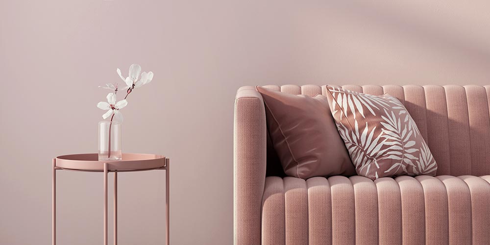 Pink painted wall with pink sofa and cushions
